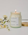 Ivy & Willow Botanicals candle with a floral branch on a white background