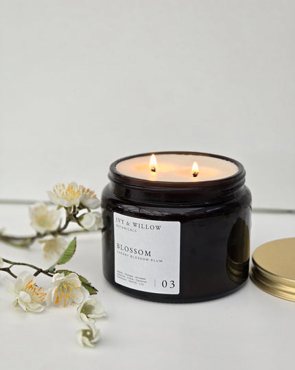Black candle jar with 'Fay & Willow' label on a light gray background
