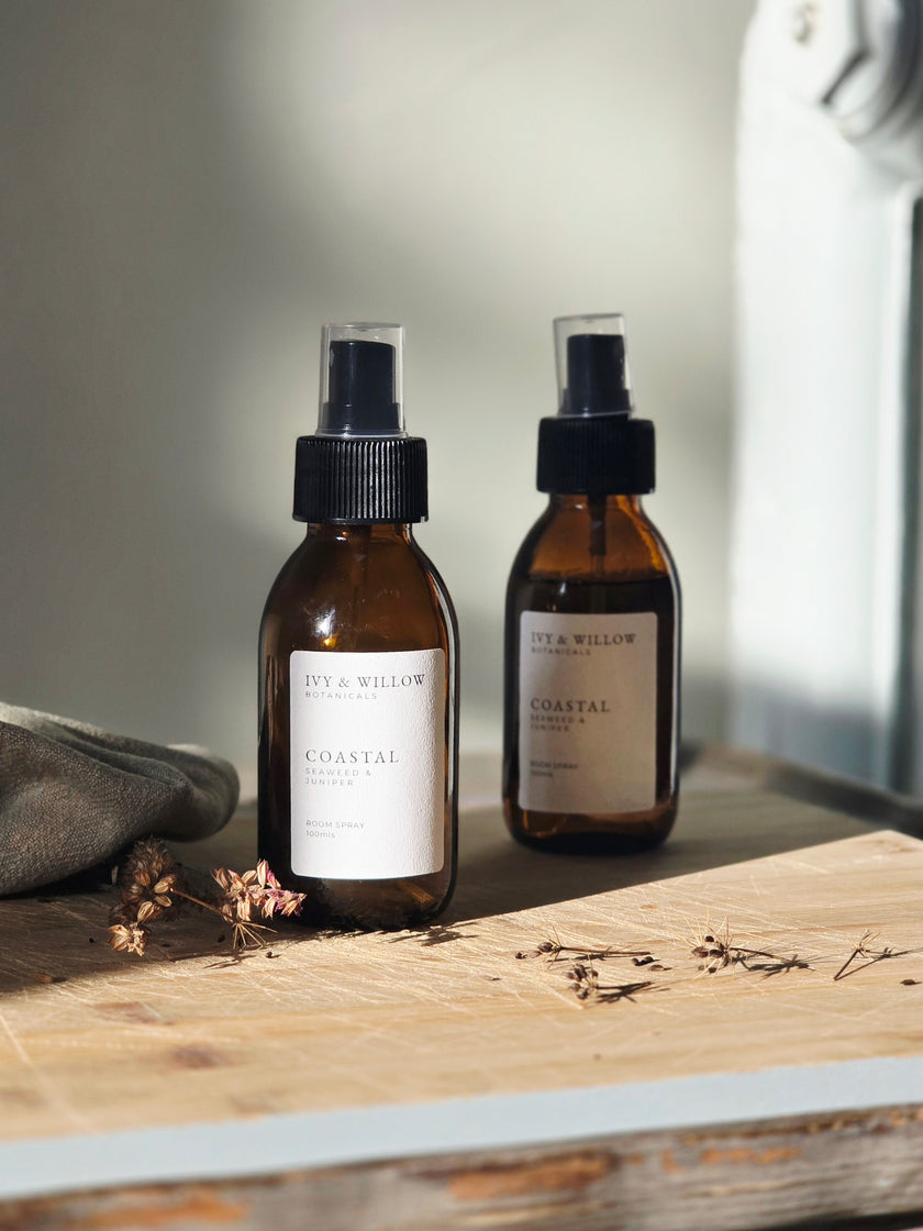 Two brown bottles with black sprayer lids on a wooden surface, labeled 'City & Willow'.