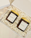 Two candles in a gift box with decorative paper