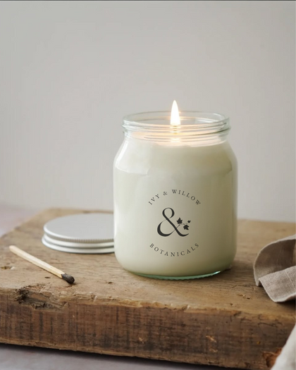 Signature clear Honey Jar 300g candle with gold lid  on a surface.