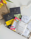 Collection of Taylors tea bags and other products on a white surface with a floral touch.