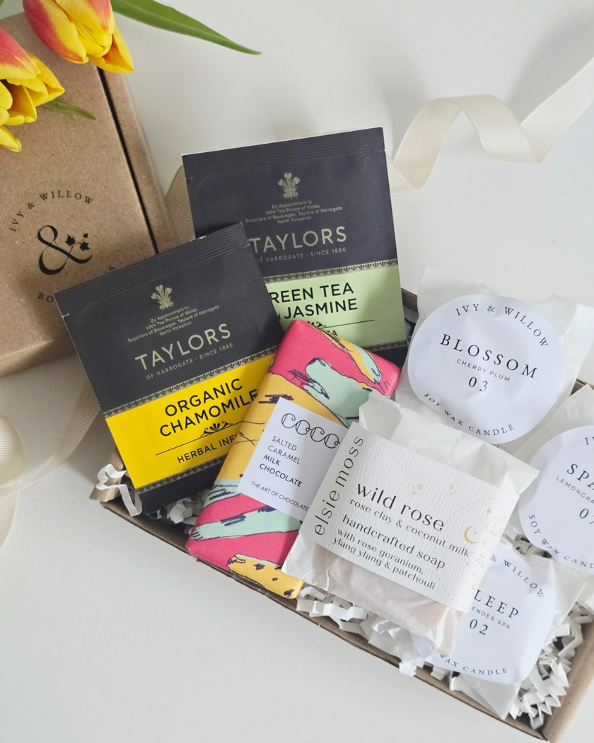 Collection of Taylors tea bags and other products on a white surface with a floral touch.