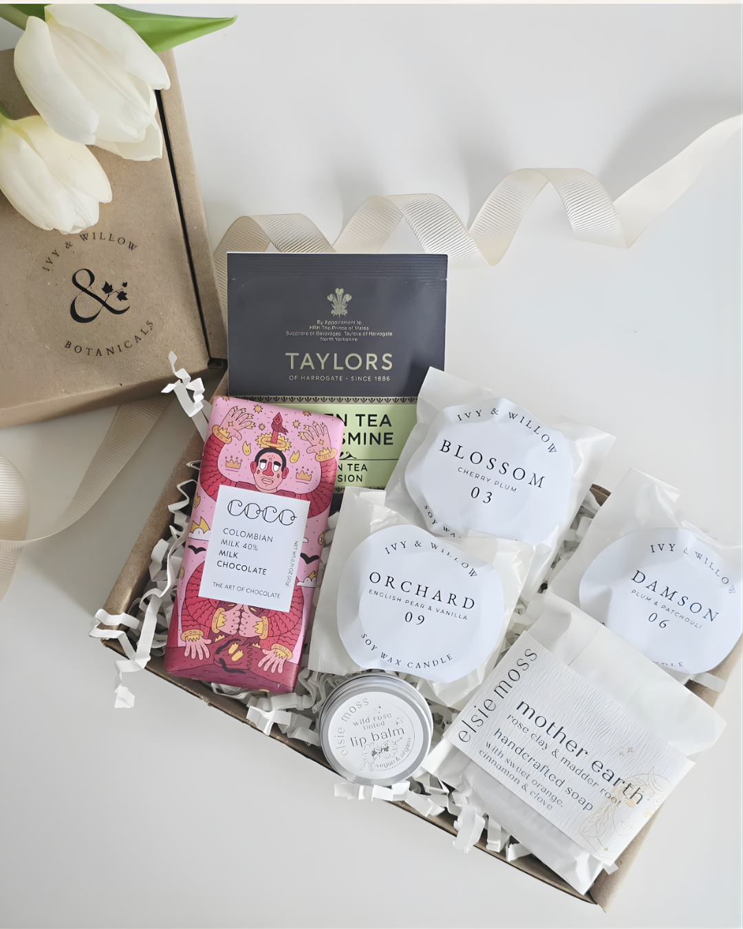 Collection of tea bags and small containers with visible branding on a white background