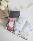 Collection of tea bags and small containers with visible branding on a white background