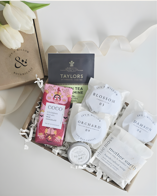 Collection of tea bags and small containers with visible branding on a white background