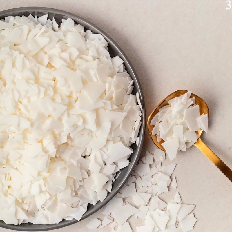 Coconut flakes on a plate with a gold spoon