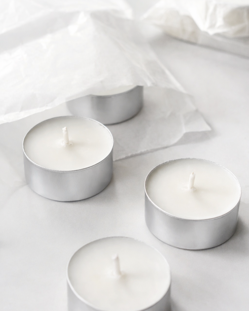 Four Tealights 20mls in silver aluminium holders on a light gray background