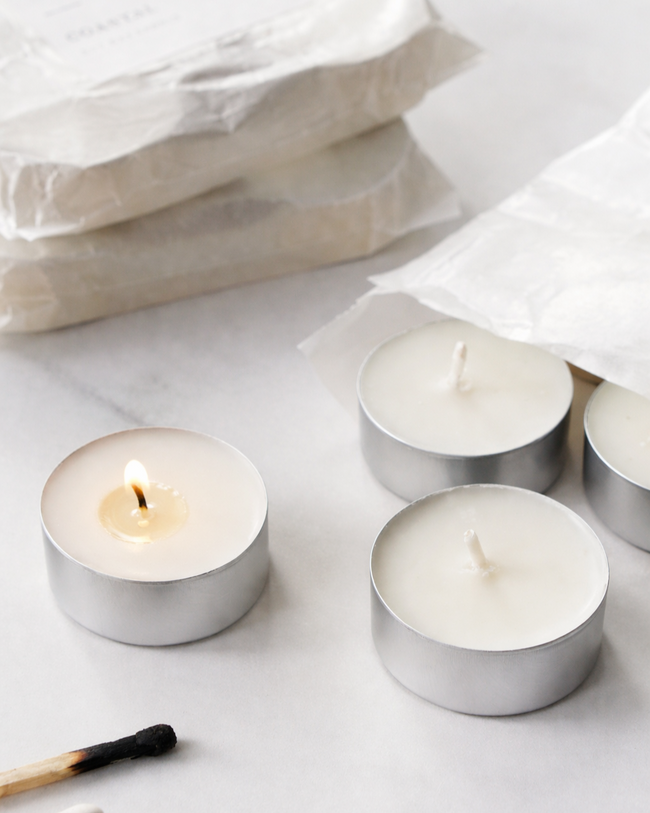 Four Tealights 20mls in silver aluminium holders on a light gray background