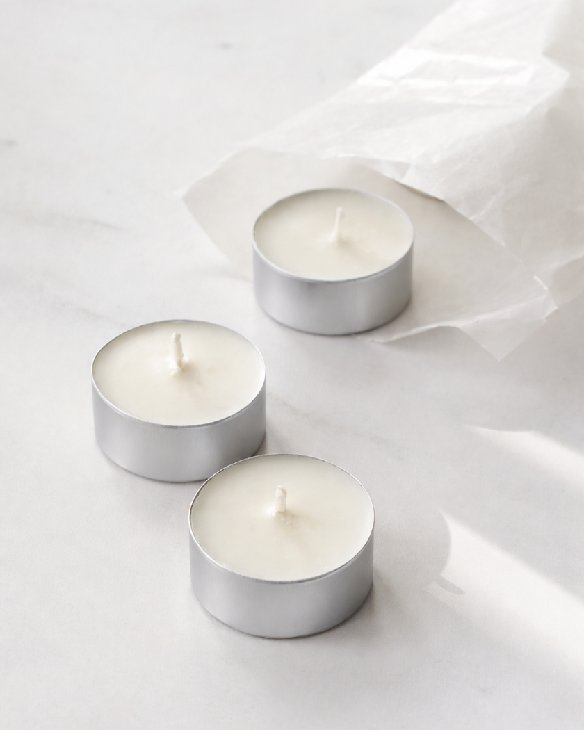 Three Tealights 20mls in silver aluminium holders on a light gray background