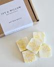 IVY & WILLOW Botanicals soy wax melts on a white surface with a branded box.