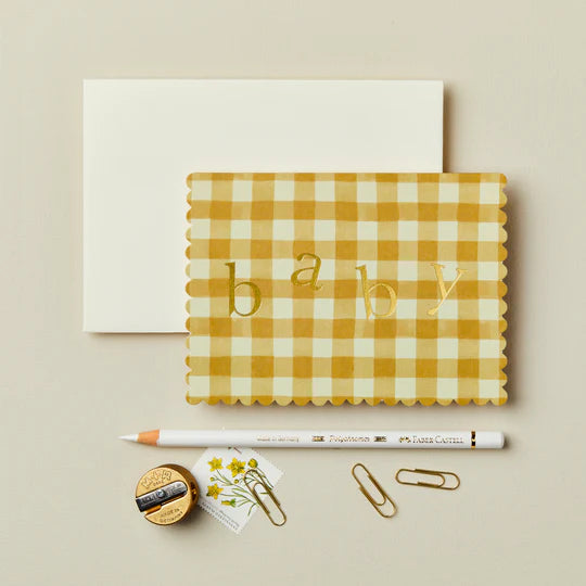 Yellow gingham card with 'baby' text on a beige background