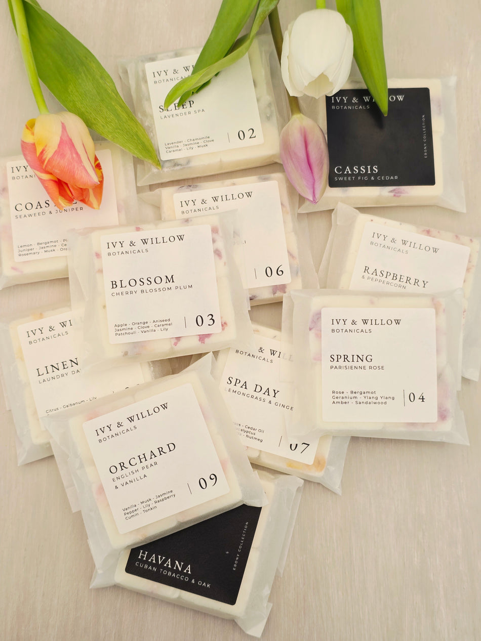 Collection of IVY & WILLOW product packaging with floral elements on a neutral background