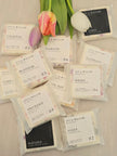 Assorted IVY & WILLOW tea packages with tulips on a light background