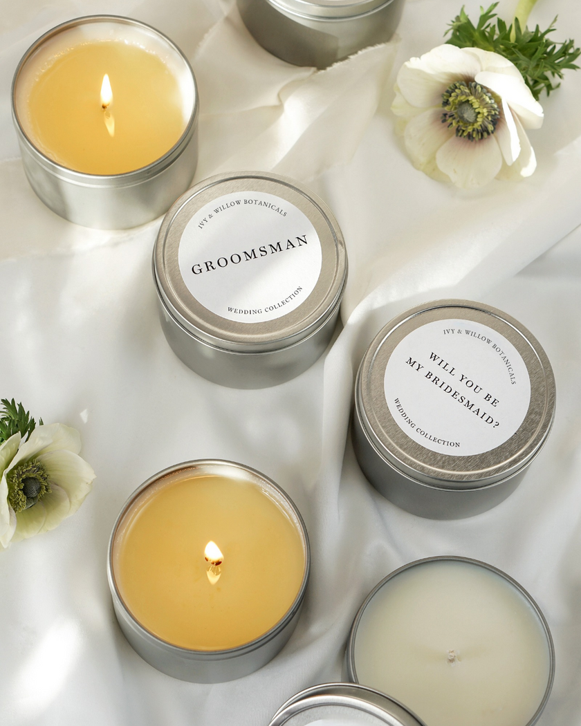 Candle favors with personalized labels on a white surface